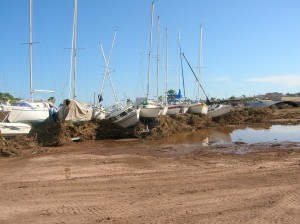 Trailer boats pushed up against the fence.